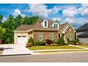 Charming, stone-accented home features dormer windows, attached garage, and manicured landscaping at 44 Ashwood Dr, Chapel Hill, NC 27516