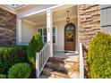 Inviting front entrance with stone steps and decorative wreath at 44 Ashwood Dr, Chapel Hill, NC 27516