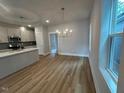 Bright eat-in kitchen features stainless appliances, breakfast bar, and modern lighting at 504 Yeowell Dr, Chapel Hill, NC 27514