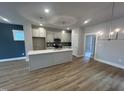 Open concept kitchen with island, stainless appliances, and adjacent dining area at 504 Yeowell Dr, Chapel Hill, NC 27514