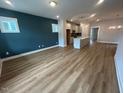 Spacious living room featuring luxury vinyl plank flooring and a modern, open-concept layout at 504 Yeowell Dr, Chapel Hill, NC 27514