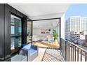 Cozy balcony with patio seating overlooking an open-concept living area with modern decor at 523 S West St # 409, Raleigh, NC 27601