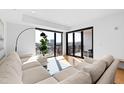 Sunlit living room with a large sectional sofa, city views, and a bright, airy feel at 523 S West St # 409, Raleigh, NC 27601