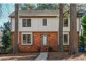 Two-story brick home featuring a symmetrical design with a well-maintained walkway leading to the front door at 5520 Sweetbriar Dr, Raleigh, NC 27609