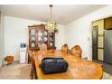 Formal dining room with chandelier, wood table, wood chairs, and china cabinet at 722 Forge Rd, Durham, NC 27713