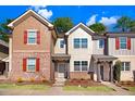 Charming townhome with brick and siding, red shutters, and landscaped front yard under a sunny blue sky at 736 Wickham Ridge Rd, Apex, NC 27539