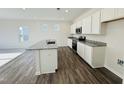 Modern kitchen boasts granite countertops, stainless steel appliances, and white cabinetry at 83 Commons Cir # 236, Clayton, NC 27520