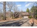 Garage on a lot with mature trees and a driveway with beautiful sunset skies at 8835 Us 64, Siler City, NC 27344