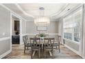 Elegant dining area with a modern chandelier and natural light from the window at 917 Sequoia Ridge Dr, Fuquay Varina, NC 27526