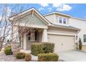 Charming home with a two-car garage, stone accents, manicured landscaping and welcoming front porch at 1003 Branwell Dr, Durham, NC 27703