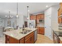 Open kitchen with stainless steel appliances, a granite island, hardwood floors and eat in kitchen area at 1003 Branwell Dr, Durham, NC 27703