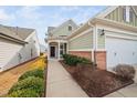 Inviting front entrance with a brick accent wall and manicured landscaping at 124 Currituck Ln, Durham, NC 27703