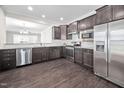 Modern kitchen with stainless steel appliances and dark wood cabinets at 124 Currituck Ln, Durham, NC 27703