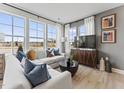 Elegant living room with expansive windows, plush sofas, and contemporary accents at 1247 Shaw View Alley # 101, Raleigh, NC 27601