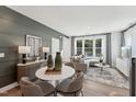 Bright living room features stylish decor, accent wall, large windows, and elegant furniture at 1259 Shaw View Alley # 101, Raleigh, NC 27601