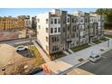 Modern townhome with brick and siding facade, showcasing contemporary design and inviting curb appeal in a residential area at 1259 Shaw View Alley # 201, Raleigh, NC 27601