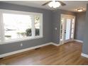 Bright living room featuring hardwood floors, a large window and entry door with side windows at 136 Dogwood Trl, Wendell, NC 27591