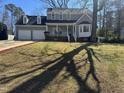 Beautifully landscaped front yard leading up to this gray two-story home at 208 Lawrence Rd, Cary, NC 27511