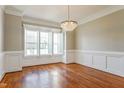Elegant dining room with hardwood floors, decorative molding, and large windows at 215 Oak Island Ct, Garner, NC 27529