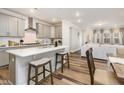 Modern kitchen with gray cabinets, stainless steel appliances, and a large island with seating at 2212 Jollay St, Durham, NC 27703