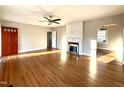 Spacious living room featuring gleaming hardwood floors, fireplace, and a bright red front door at 2409 Shenandoah Ave, Durham, NC 27704