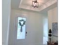 Bright entryway with decorative light fixture and view of front door at 244 Bevis Marks Dr, Fuquay Varina, NC 27526