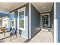 Inviting front porch featuring seating, with classic blue siding and white trim detailing at 244 Bevis Marks Dr, Fuquay Varina, NC 27526