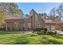 Brick home features a large picture window, beautiful landscaping and a two-car garage at 2520 Summit Ln, Creedmoor, NC 27522