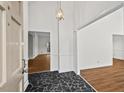 Inviting foyer with black tile flooring and an elegant pendant light fixture at 2520 Summit Ln, Creedmoor, NC 27522