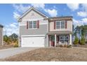 Charming two-story home with a two-car garage, a cozy front porch, and a manicured lawn at 2815 E Brookwood Ct, Creedmoor, NC 27522