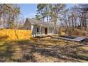 Well-maintained single-story home featuring a tidy lawn, wood fence, and inviting covered front porch at 318 Holland Glen St, Fuquay Varina, NC 27526