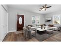 Bright living room features wood floors, modern furnishings, and a decorative fireplace, perfect for relaxation at 318 Holland Glen St, Fuquay Varina, NC 27526