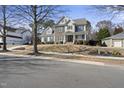 Traditional two-story home with manicured lawn on a sunny day at 324 Stearns Way, Wake Forest, NC 27587