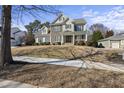 Traditional two-story home with stone accents and manicured front lawn at 324 Stearns Way, Wake Forest, NC 27587