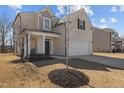View of a two-story home with a two-car garage and simple landscaping at 40 Glendavis Hollow Dr, Franklinton, NC 27525