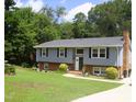 Inviting two-story home with landscaped yard, charming brick accents, and lush green lawn at 4408 Leota Dr, Raleigh, NC 27603