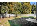 Spacious backyard with grass, patio, shed, and a privacy fence, perfect for outdoor activities at 5129 Chasteal Trl, Raleigh, NC 27610