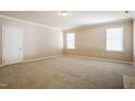 Expansive bedroom featuring neutral carpet, natural light, and ample space at 5129 Chasteal Trl, Raleigh, NC 27610