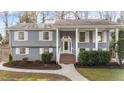 Inviting home featuring a classic design with white trim, brick accents, and a welcoming entrance at 5412 Farley Dr, Raleigh, NC 27609