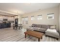 Spacious living room with ample natural light, wood floors, and an open kitchen in the background at 5439 Ripplebrook Rd, Durham, NC 27712
