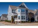 Charming gray two-story home with white trim, landscaped yard, and a welcoming entrance at 5501 Advancing Ave, Raleigh, NC 27616