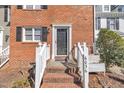 Charming brick home entrance with well-maintained landscape and welcoming front door at 6036 Epping Forest Dr, Raleigh, NC 27613