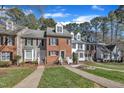 Attractive multi-Gathering homes featuring manicured lawns, mature trees, and blue skies at 6036 Epping Forest Dr, Raleigh, NC 27613