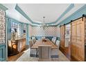 Elegant dining room featuring trey ceiling, wainscotting, and a sliding barn door at 6532 Wakefalls Dr, Wake Forest, NC 27587