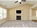 Spacious living room with a fireplace and television, offering an inviting area for relaxation and entertainment at 66 Shetland Ln, Smithfield, NC 27577