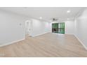 Bright and airy living room boasting wood floors and access to a cozy outdoor balcony at 689 Pine Ridge Pl, Raleigh, NC 27609
