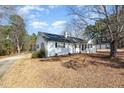 Spacious single story with mature trees and a long driveway at 7722 Nc 27 W, Lillington, NC 27546