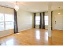 Spacious living room with hardwood floors, a modern chandelier, and bright natural light at 8 Weeping Beech Way, Durham, NC 27713