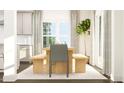 Bright dining area with a wooden dining table and bench seating near a window and modern decor at 917 Thimbleweed Way, Wake Forest, NC 27587