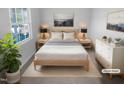 Bright bedroom featuring natural wood furniture, soft neutral tones, and a view from the window at 1216 Armstrong Cir, Raleigh, NC 27610